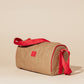 Slim insulated lunch cooler bag in beige with adjustable vibrant red crossbody strap on neutral background