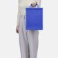 Out of the Ocean® Reusable Lunch Bag with Click N' Stay® held by person, showcasing durable blue fabric bag.