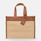 Tote bag with brown leather top half and jute bottom half on a white background