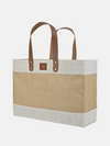 Natural jute market tote bag with sturdy leather handles and spacious design for everyday essentials or shopping.