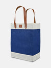 Jute Tall Tote in blue and natural jute with sturdy brown handles perfect for market trips and day excursions.