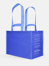 Shopper with Click N' Stay® Extra Large blue reusable bag made from ocean plastic with long handles and side text.