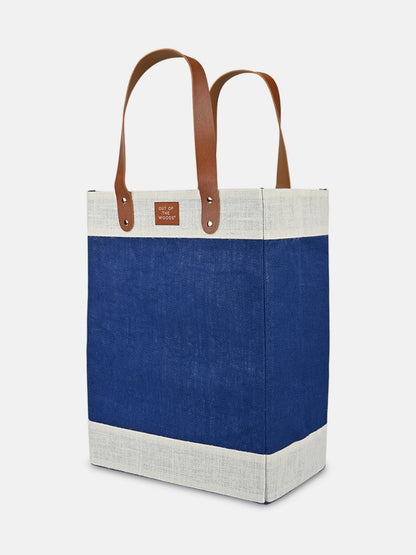 Jute Tall Tote in blue and natural jute with sturdy brown handles perfect for market trips and day excursions.