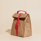Paper Sack Lunch Cooler with fold-top design, red buckle, lightweight reusable insulated lunch bag in brown.